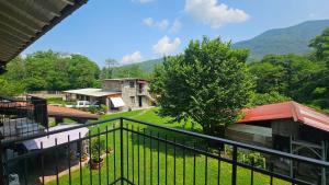 a view from a balcony of a house with a tree at Agriturismo dei Laghetti in Porto Valtravaglia