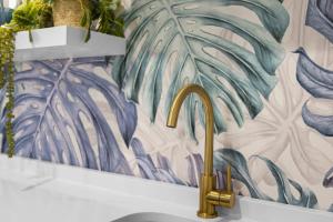 a sink with a gold faucet in a bathroom at Azul - An Atomic Ridge Home in Chattanooga +61 photos