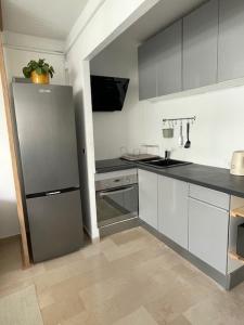 a kitchen with a refrigerator and a sink at Appartement à vence in Vence