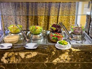 a buffet with several bowls of food on a table at Prince Omar Boat in Cairo