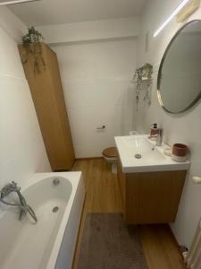 a bathroom with a tub and a sink and a mirror at Appartement à vence in Vence +6 photos