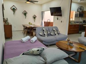 a living room with a couch and a table at Casa con alberca privada in Puerto Vallarta