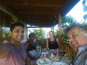 a group of people sitting around a table at The Pool House in Saint Philip