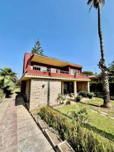 a house with a palm tree in front of it at Villa Grao Benicasim REF 026 in Grao de Castellón +68 photos