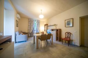 a kitchen and living room with a table and chairs at Villa Maria in Volterra