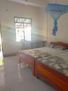 Una cama o camas en una habitación de Niluka Rest