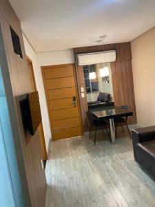 a living room with a table and a dining room at One Flat 31 in Pará de Minas +3 photos