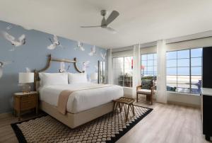 a bedroom with a bed with birds on the wall at The Milo in Santa Barbara