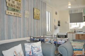 a living room with a couch and a table at 13 Hillside in Bude