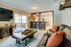 a living room with a couch and a table at Hot Tub and Outdoor Kitchen Stylish Home in Bryan in Bryan