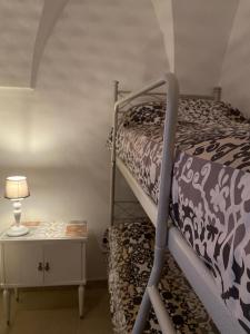 a bedroom with a bunk bed and a night stand at In centro da Cinzia in Ostuni