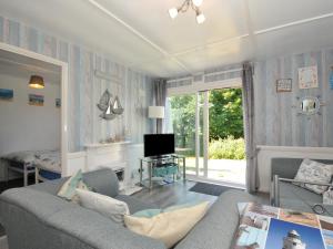 a living room with a couch and a tv at 13 Hillside in Bude