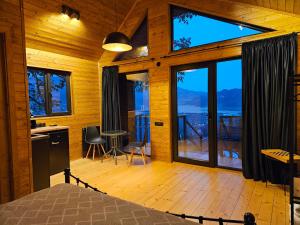 a bedroom with large windows and a view of the mountains at Mtskheta Chalet in Mtskheta +15 photos