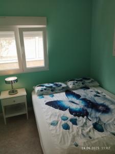 a bedroom with a bed and two windows at Apartment Mariposa Azul in Icod de los Vinos