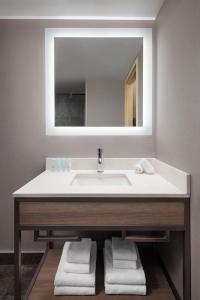 a bathroom with a sink and a mirror at Grande Rockies Resort-Bellstar Hotels & Resorts in Canmore +20 photos