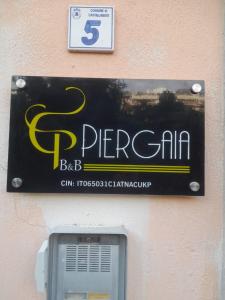 a sign on a wall with a pay phone at B&B PierGaia in Santa Maria di Castellabate