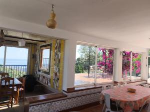 a dining room with a table and some windows at Villa López in Cómpeta