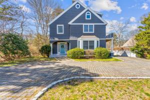 a blue house with a driveway at Summer by the Sea - Central to all beaches & ponds in Mashpee