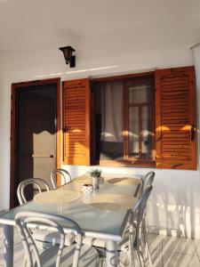 a dining room with a table and chairs at Isminis country house in Vergia +6 photos