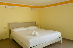 a bedroom with a bed with two white pillows at Harmonia Apartment with breathtaking view and a perfect location in Tropea