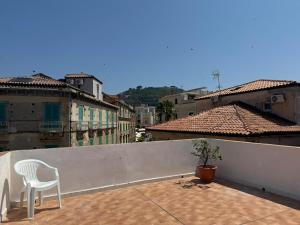 a white chair sitting on top of a roof at Harmonia Apartment with breathtaking view and a perfect location in Tropea