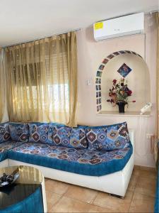 a living room with a couch and a window at Dar lborj in Kelibia +12 photos