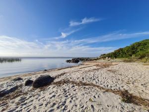 a sandy beach with a view of the water at Complejo Anjuá in Punta Del Diablo