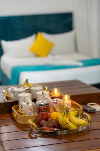a tray of fruit and candles on a table at Chitta in Nikawatawana