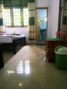 a bedroom with a bed and a sink and a mirror at Greenwood Udawalawa Safari Resort in Udawalawe