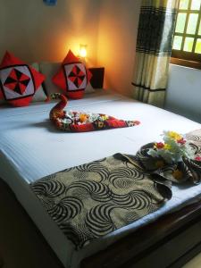 a bedroom with a bed with a snake on it at Greenwood Udawalawa Safari Resort in Udawalawe