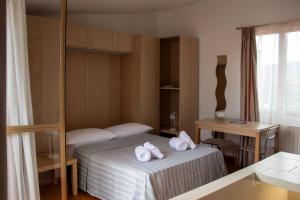 a hotel room with a bed with towels on it at Locanda del Gufo Civezza in Civezza