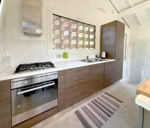 a kitchen with a stove and a sink at The Relax Barn in San Casciano in Val di Pesa