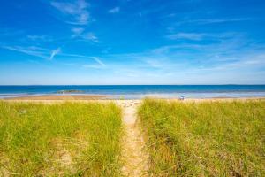 a path through a field of grass on a beach at Beachfront and only 30 Steps To Beach in Saco