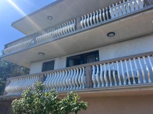 a white railing on a balcony of a house at Apartman MK in Kruče