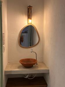 a bathroom with a bowl sink and a mirror at Cabaré Du Vento in Prea +66 photos