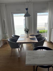 a dining room with a wooden table and chairs at Penthouse Apartment in Gießen