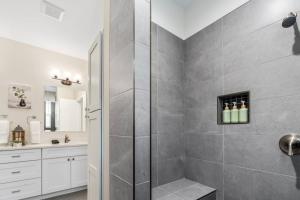 a bathroom with a shower stall and a sink at Stylish Revival Retreat w Hot Tub and Fire Pit in Cottonwood +41 photos