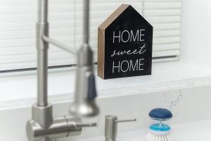 a sign that says home sweet home next to a sink at Cozy Millcreek Home SLC in Millcreek +52 photos