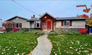 a house with a red door and a sidewalk at Cozy Millcreek Home SLC in Millcreek