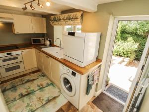 a kitchen with a washer and dryer in it at Corner Cottage in Carnforth
