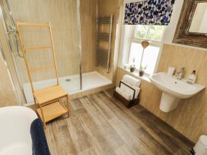 a bathroom with a shower and a sink and a toilet at Corner Cottage in Carnforth +32 photos