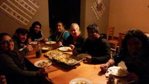 a group of people sitting around a table eating food at Casa de Turistas La Rinconada in Chacas
