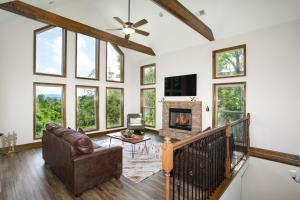 a living room with a couch and a fireplace at Smokeys Summit Epic View Hot Tub Fireplace in Sevierville