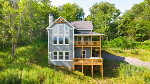 a tiny house in the middle of a field at Smokeys Summit Epic View Hot Tub Fireplace in Sevierville