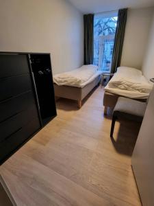 En eller flere senge i et værelse på Central Apartment for 4