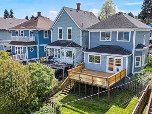 a large blue house with a large deck at Old Tacoma Victorian Main Floor Duplex Unit in Tacoma