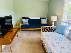 a living room with a couch and a tv at Old Tacoma Victorian Charm with water views in Tacoma