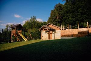 a playground with a slide and a play structure at Kuca za odmor Lovric in Verija