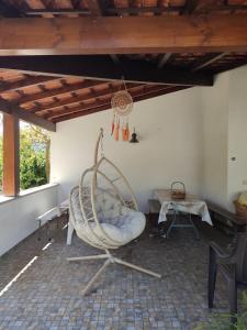 a room with a rocking chair and a table at Quinta de São João in Poios