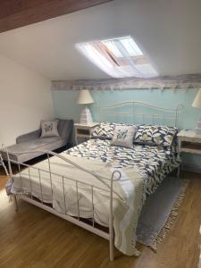 a bedroom with a bed and a skylight at Maison L’allee in Lézignac-Durand +46 photos